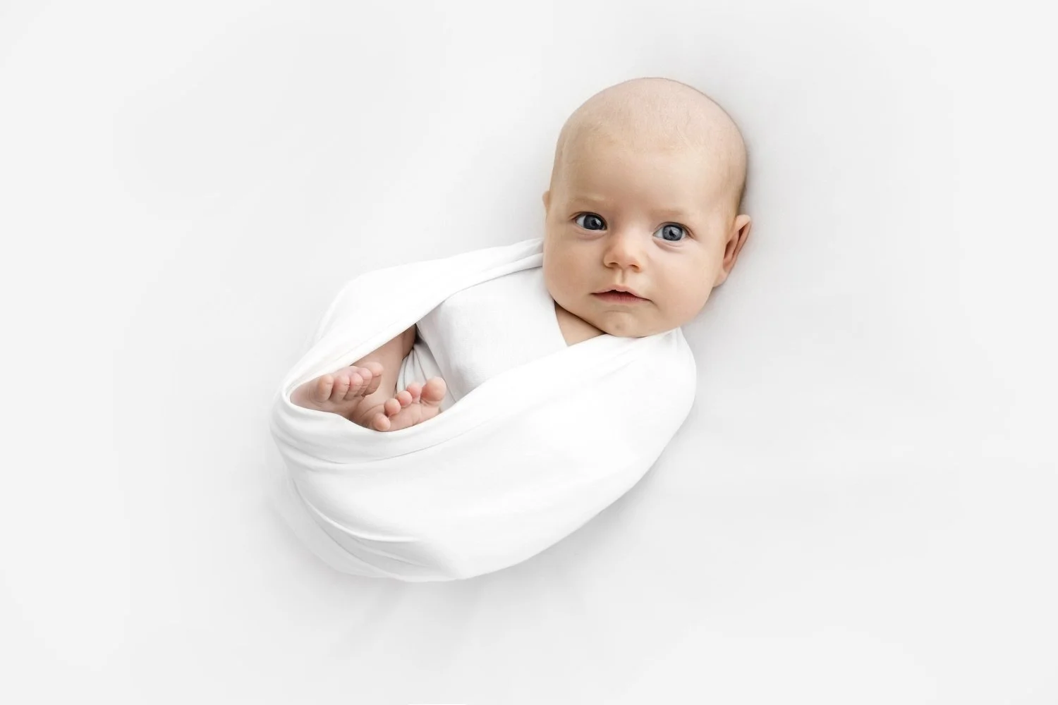 awake 7 week old baby curled up during Dundee studio photoshoot