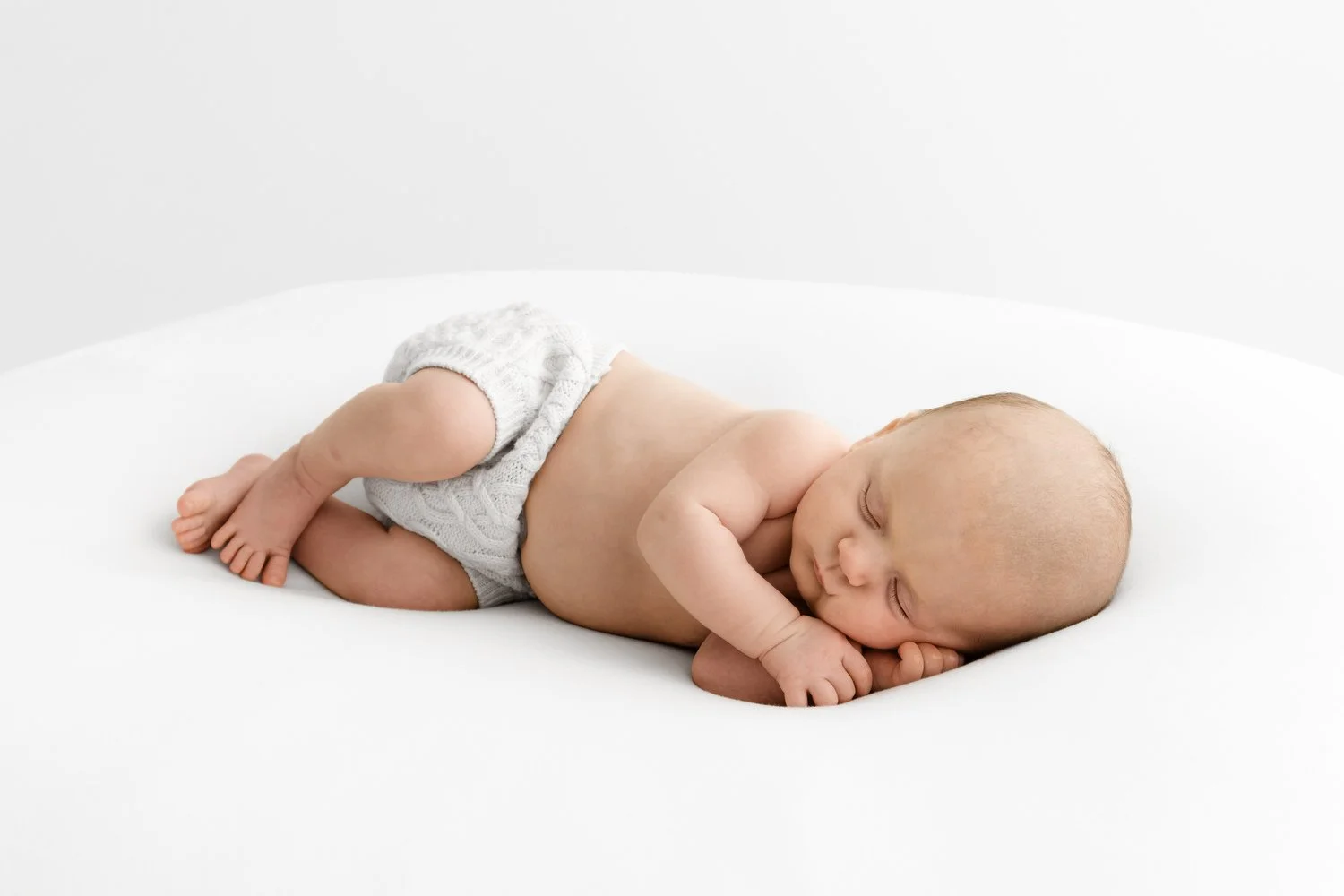 Cosy baby resting peacefully during a relaxed session at Mabel and Moose Studio Dundee