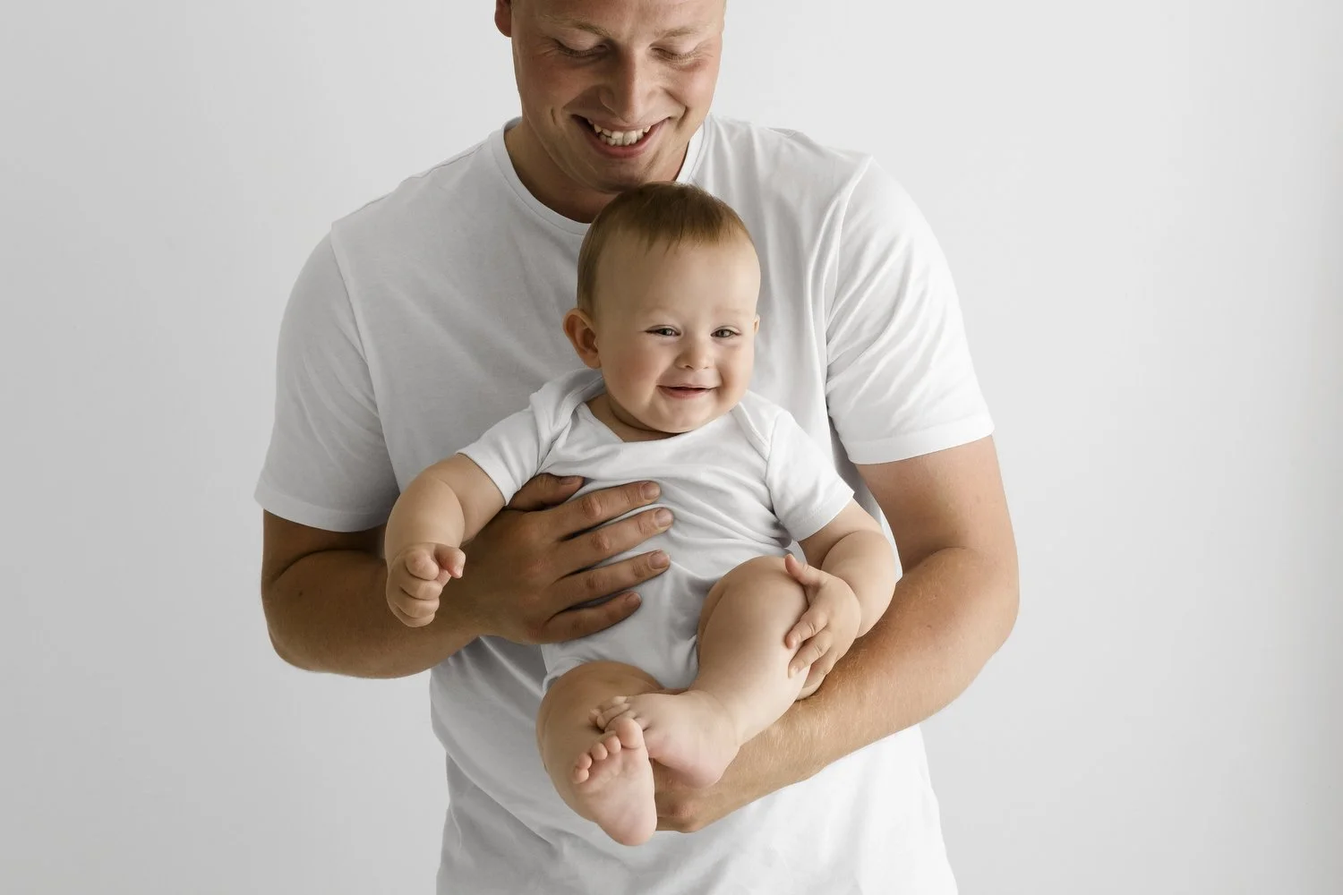 dad holding baby at Natural prop free  baby photography at Mabel and Moose studio Monifieth Dundee