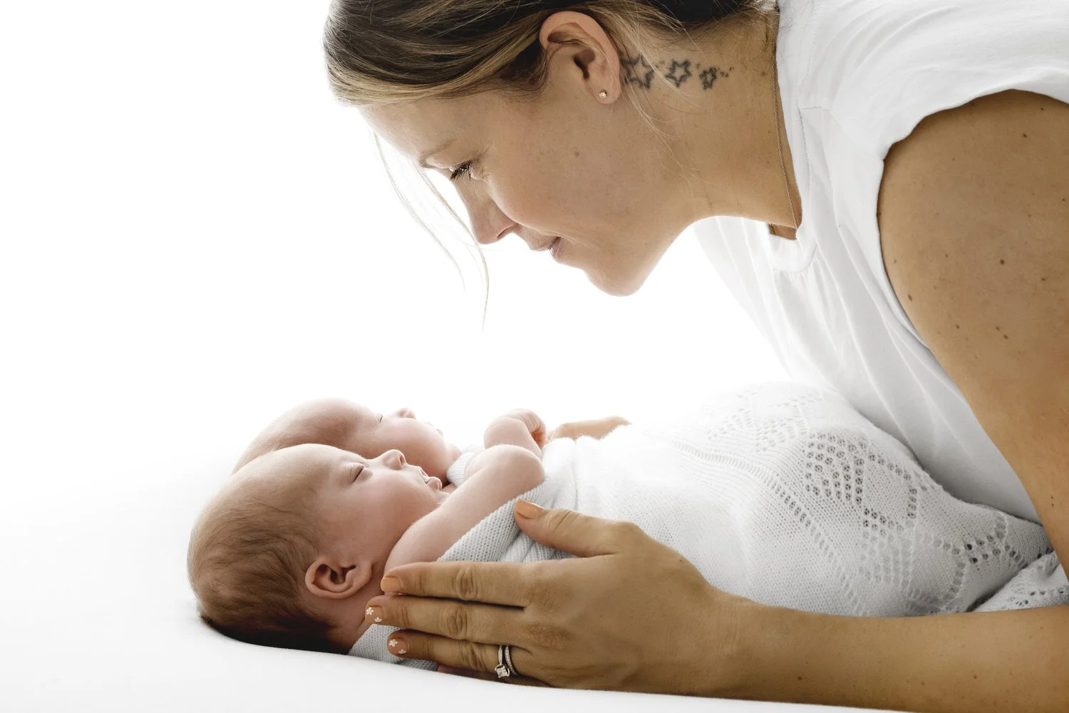 Mum holding newborn twin babies at Mabel and Moose studio Dundee