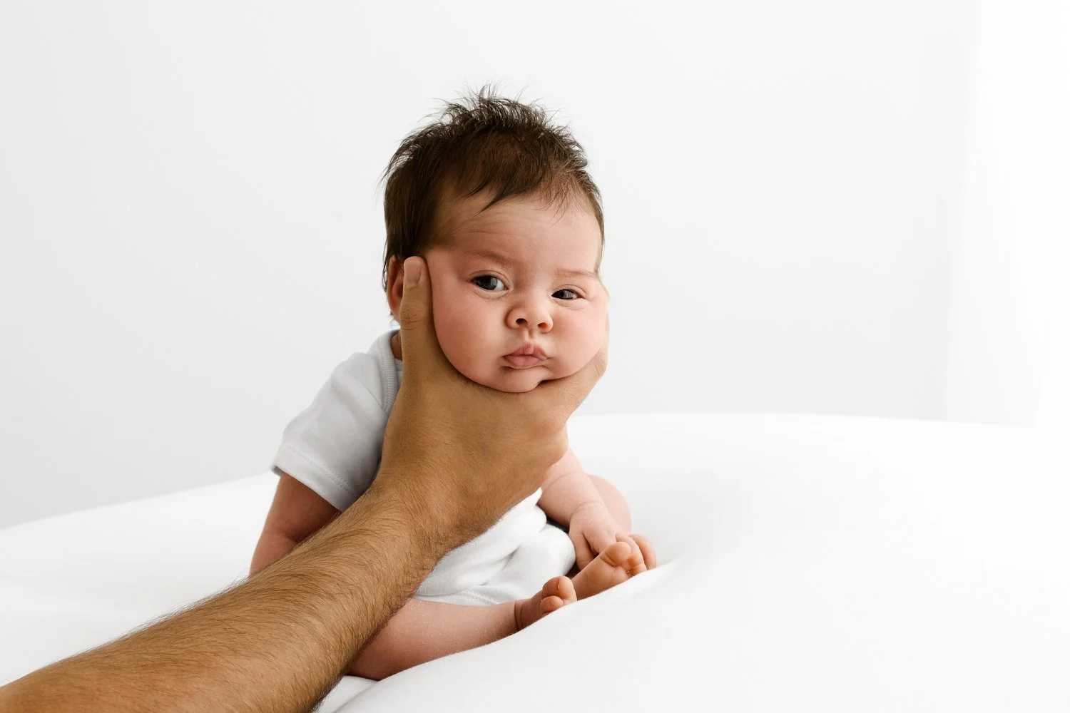Cutest dark haired baby Portrait of newborn with minimal props, demonstrating a timeless, light-filled style