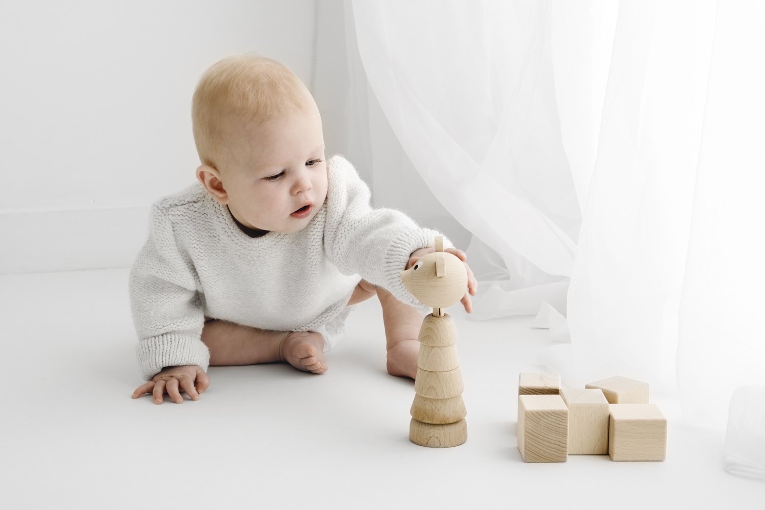 9 month old baby playing during natural baby photoshoot in Dundee