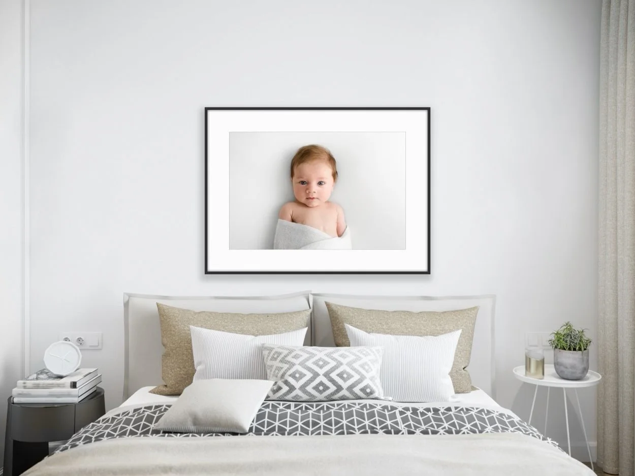 Framed baby portrait displayed in minimalist Scandinavian style room in Dundee