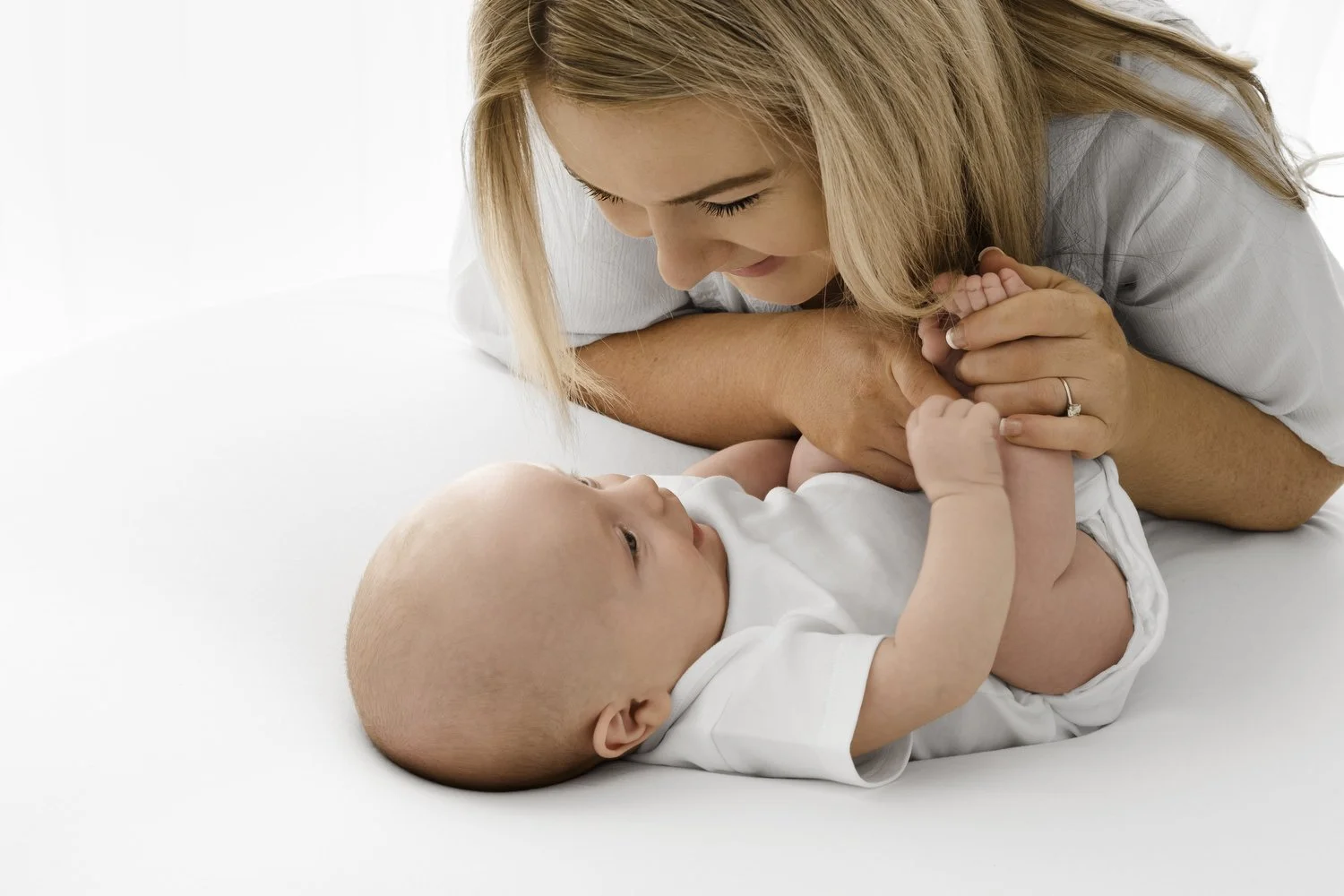Mum looking at her newborn baby at Mabel and Møøse newborn photography studio Dundee