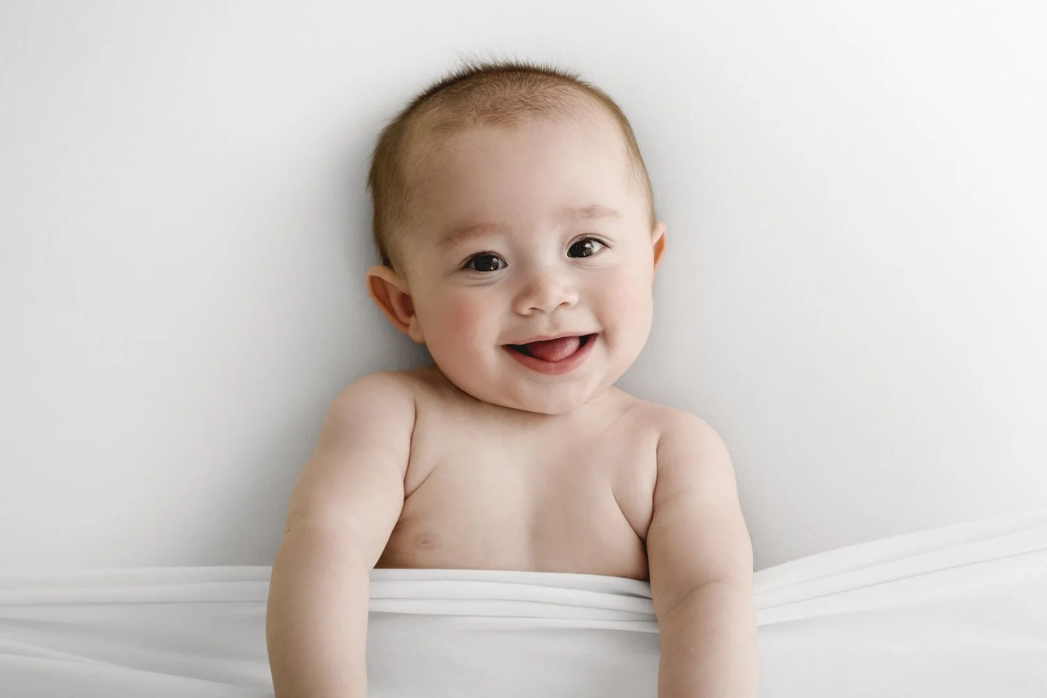 Smiling older baby looking up at camera during Dundee studio photoshoot