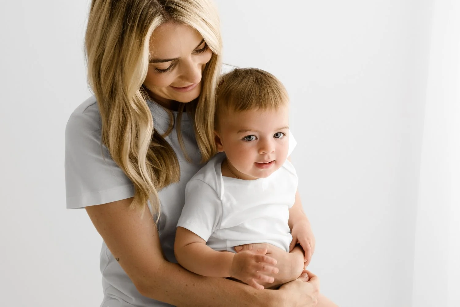 first birthday baby sitting naturally on mum's knee at a photoshoot in dundee