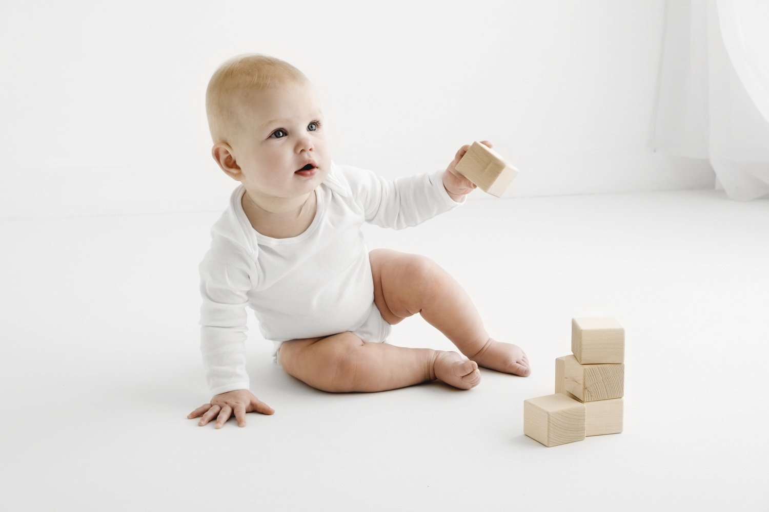 9 month old baby playing during natural baby photoshoot in Dundee