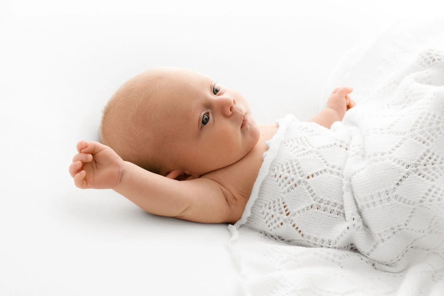Close-up of a smiling baby showing cute cheeks during a session at Mabel and Moose Studio