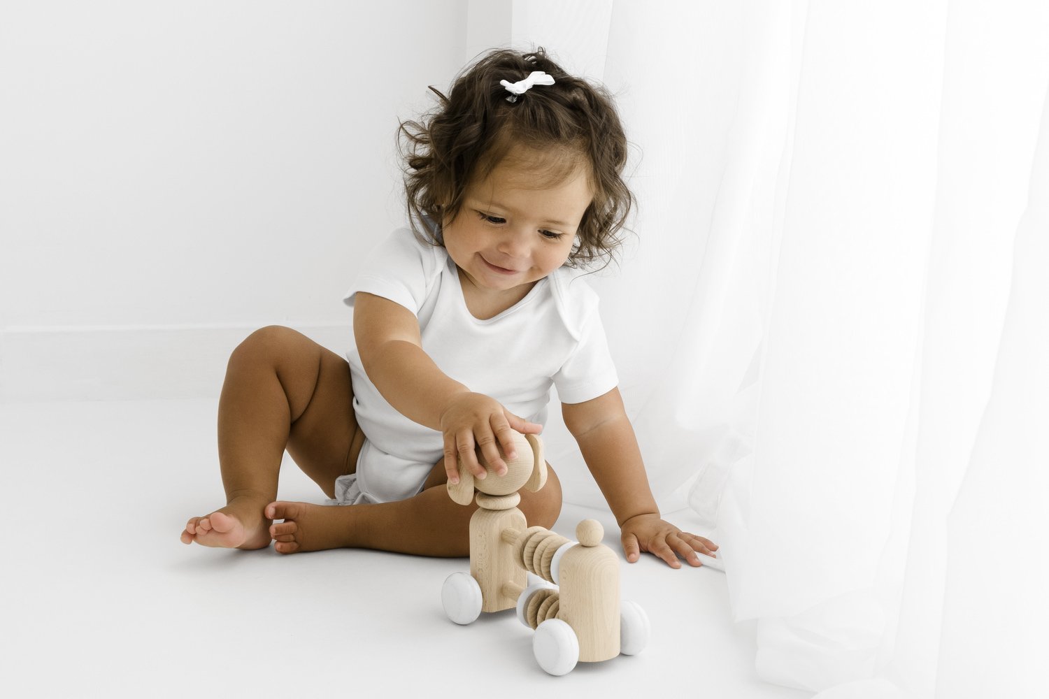 Selection of white baby bodysuit styles for newborn photography at Mabel and Moose Dundee