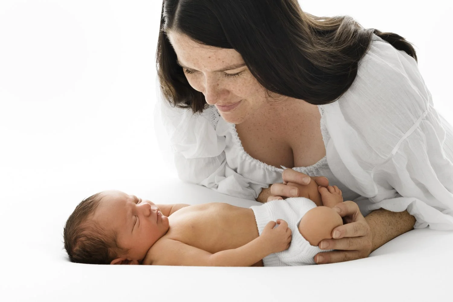 New mum holding her newborn baby at Mabel & Møøse newborn photography studio Monifieth Dundee