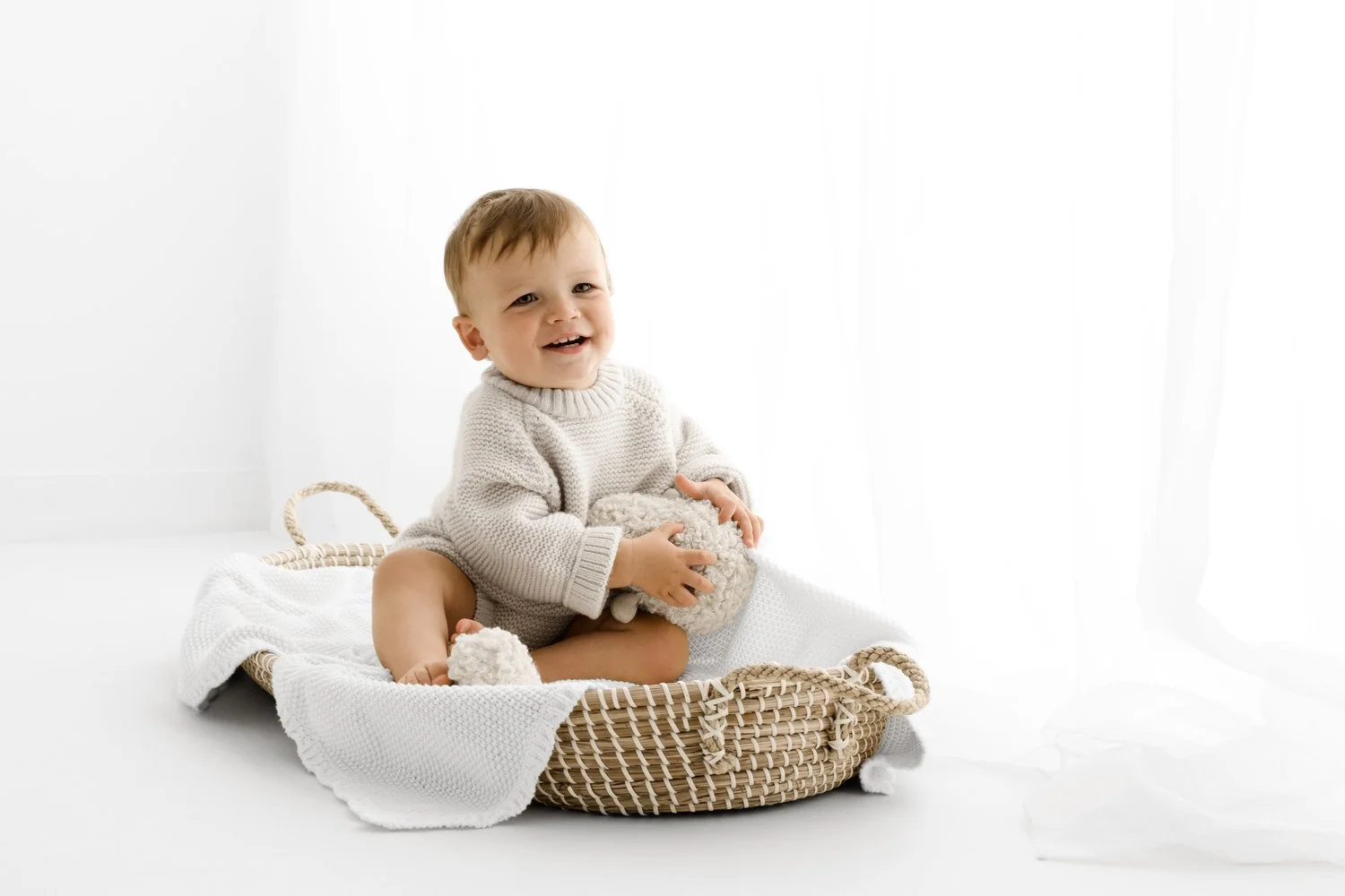 baby sitting in basket at Natural baby photography at Mabel and Moose studio Monifieth Dundee