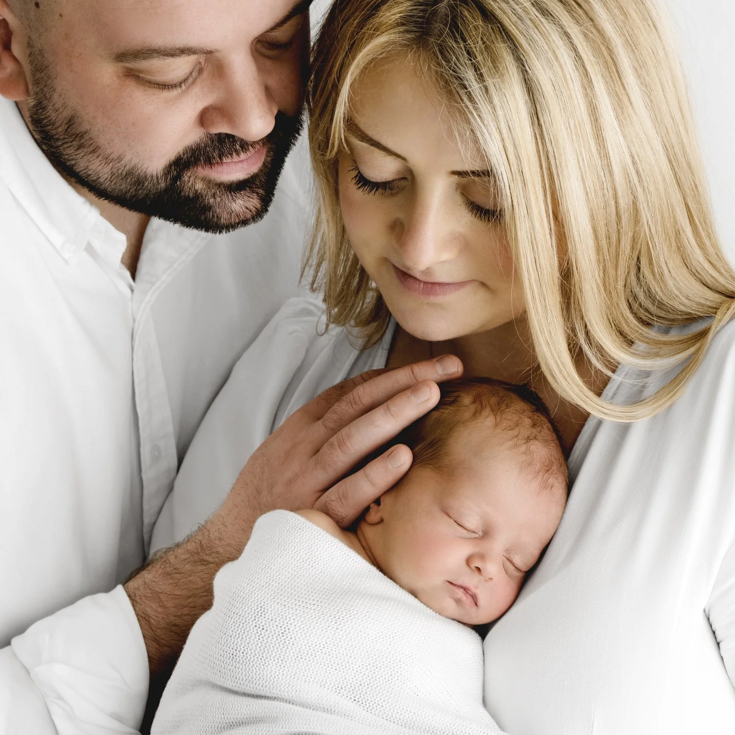 Mum and dad holding their newborn baby during Dundee studio photoshoot