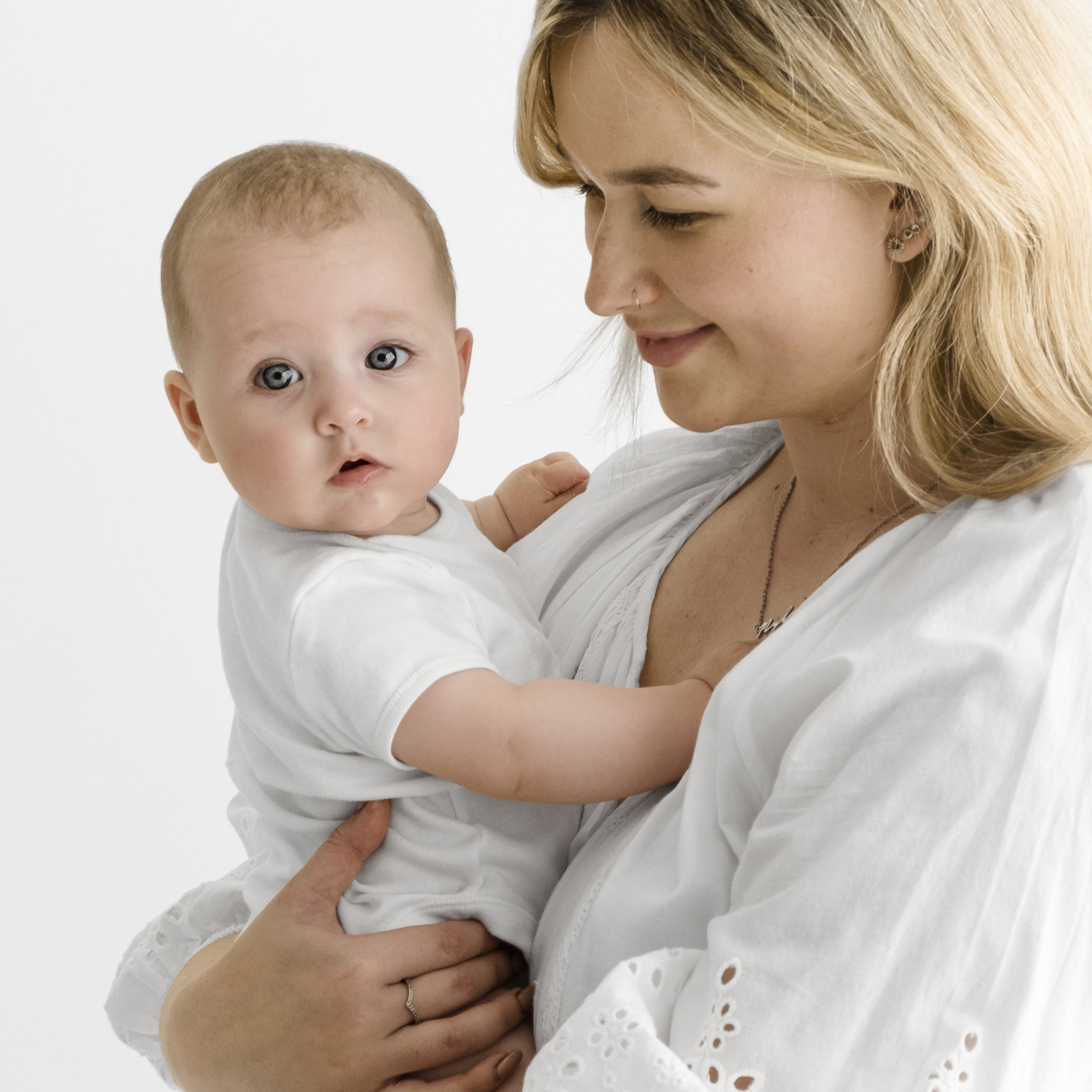 10 week  old baby held by mum in white dress during Dundee studio photoshoot
