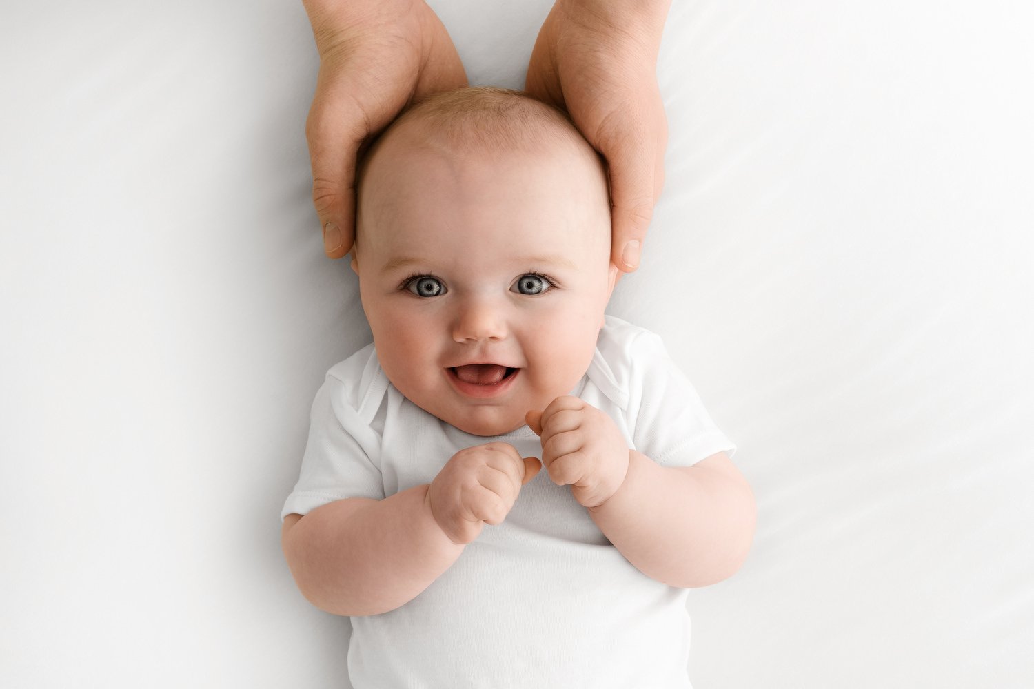 6 month old baby in dad's hands photoshoot at Mabel and Moose studio Dundee