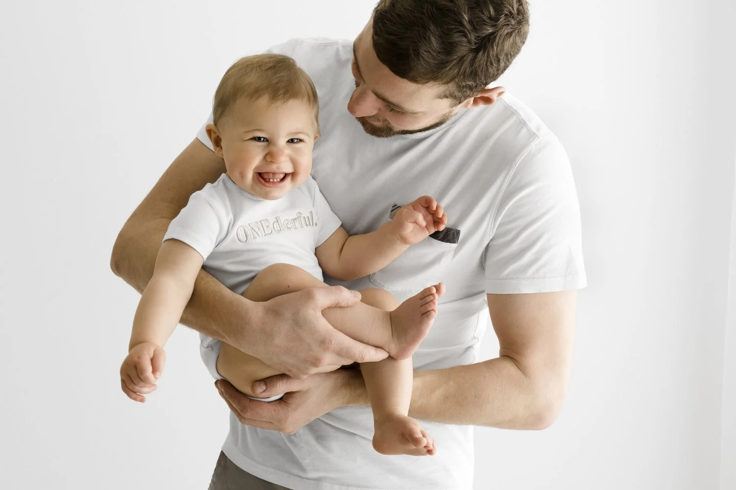 first birthday baby at a natural photoshoot in dundee being hugged by dad