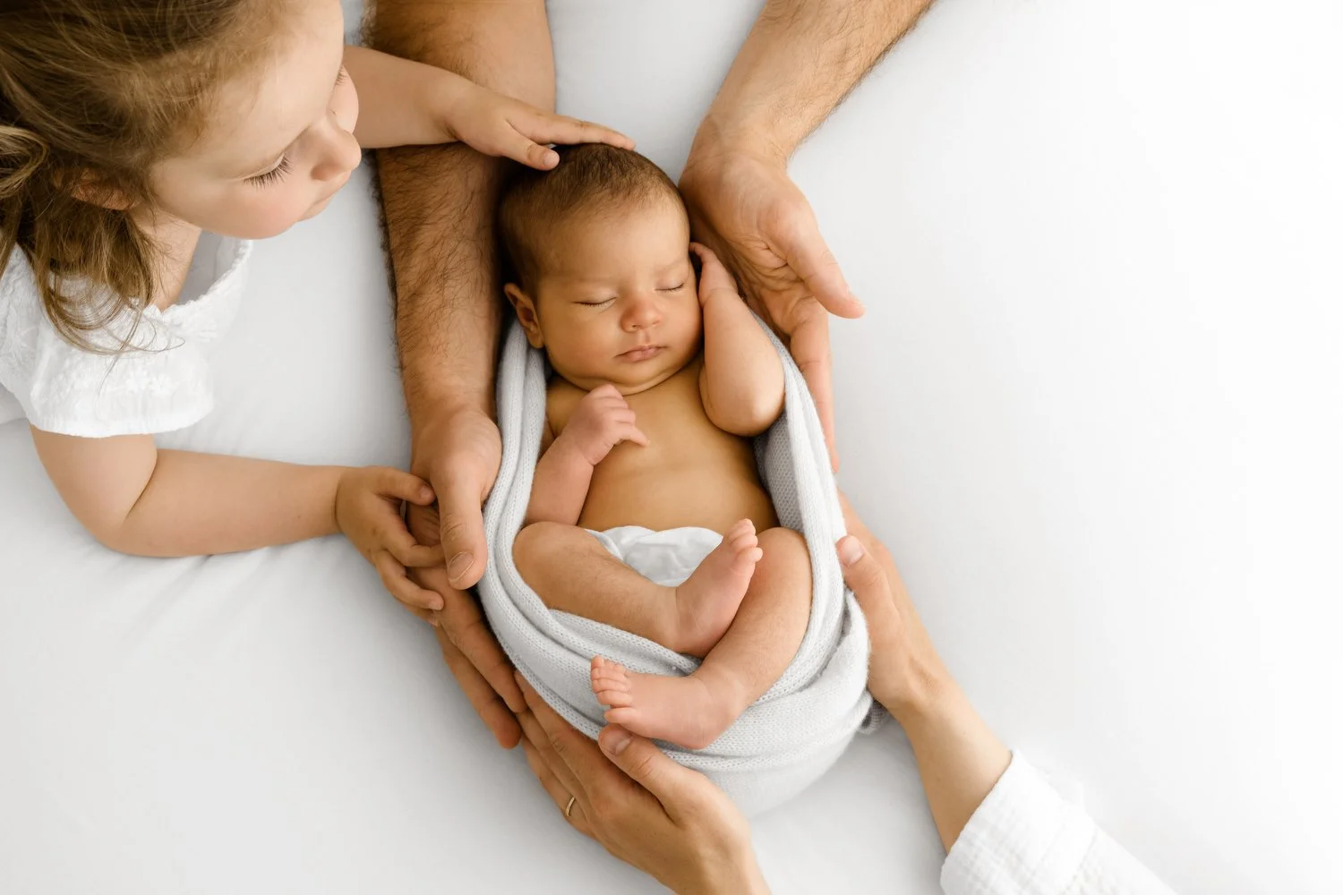 relaxed family photoshoot near dundee with newborn and toddler and parents hands