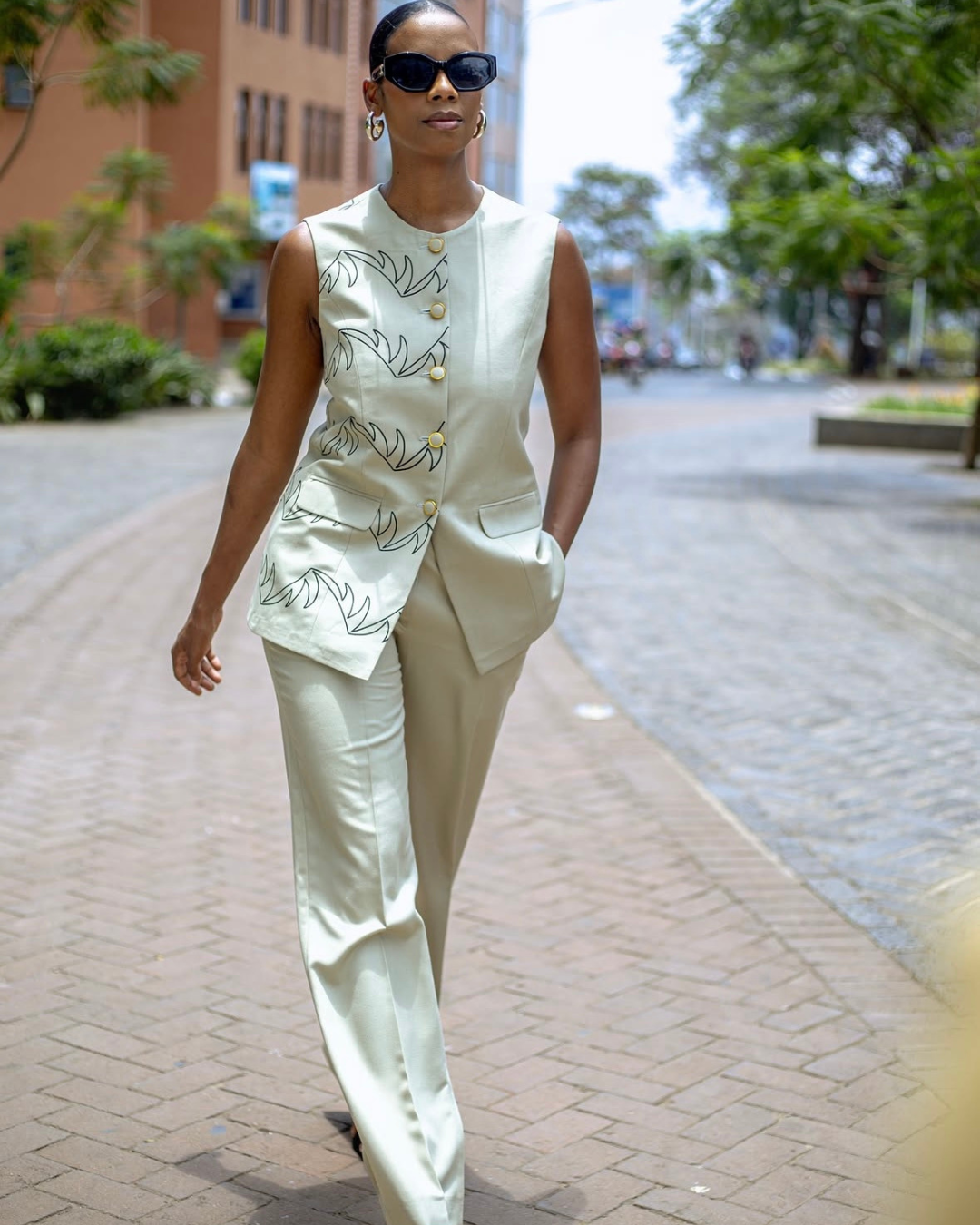 Female model wearing IZUBAA Gila Suit in beige
