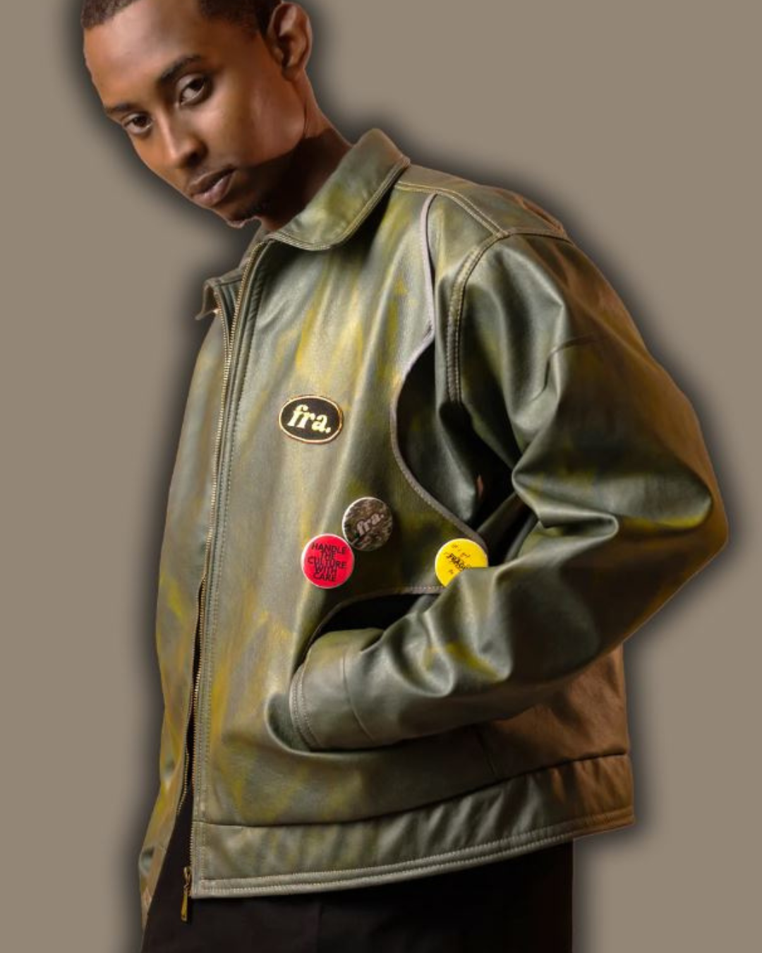 Male model wearing the FRAGILE Goldie Green Jacket