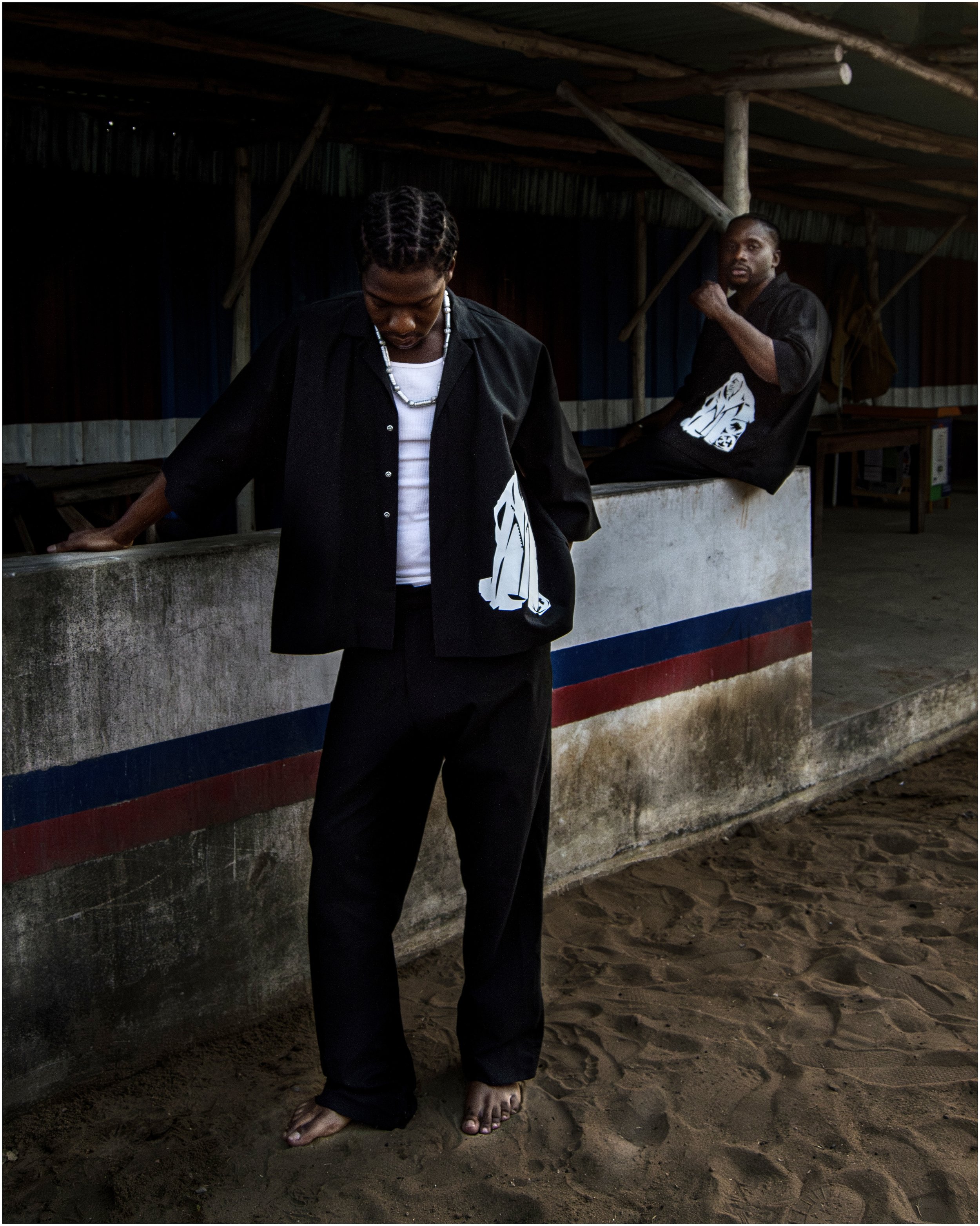 Two male models wearing black FARE sets