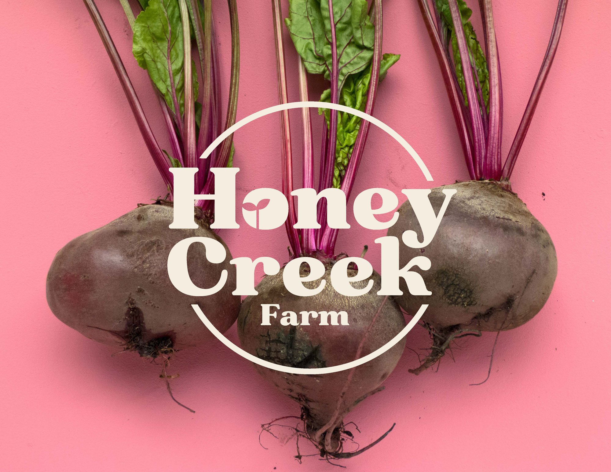  Honey Creek Farm logo overlayed on photo of beets on a pink background. 