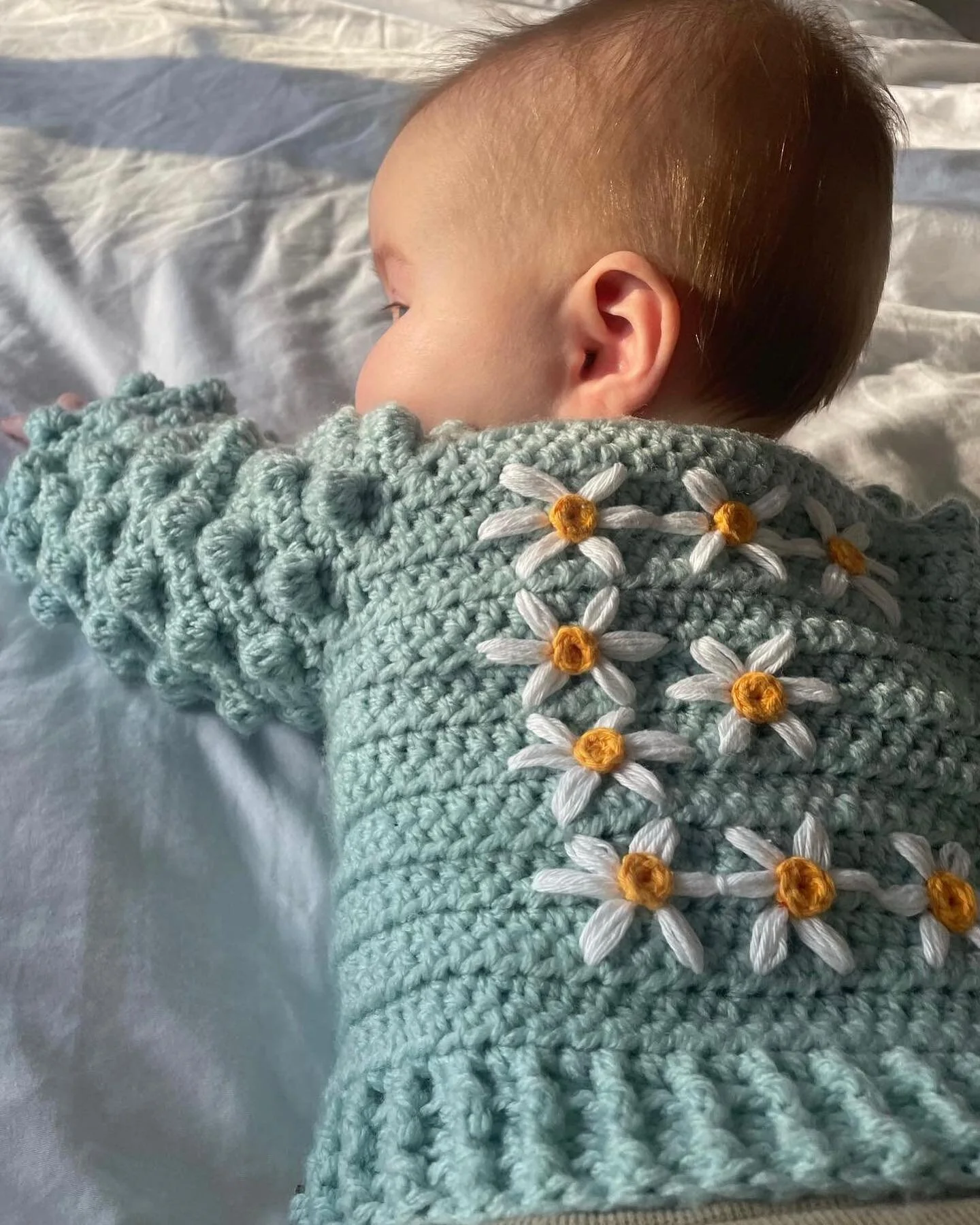 🌼🌷🌤️Spring has finally arrived and here is beautiful little Ella to prove it!! 
Ella is wearing  my Bobble Stitch Cardi in Duck Egg with her initial hand embroidered on the back in daisies. What a cute little poppet she is @lucysharp19 

&bull;

#