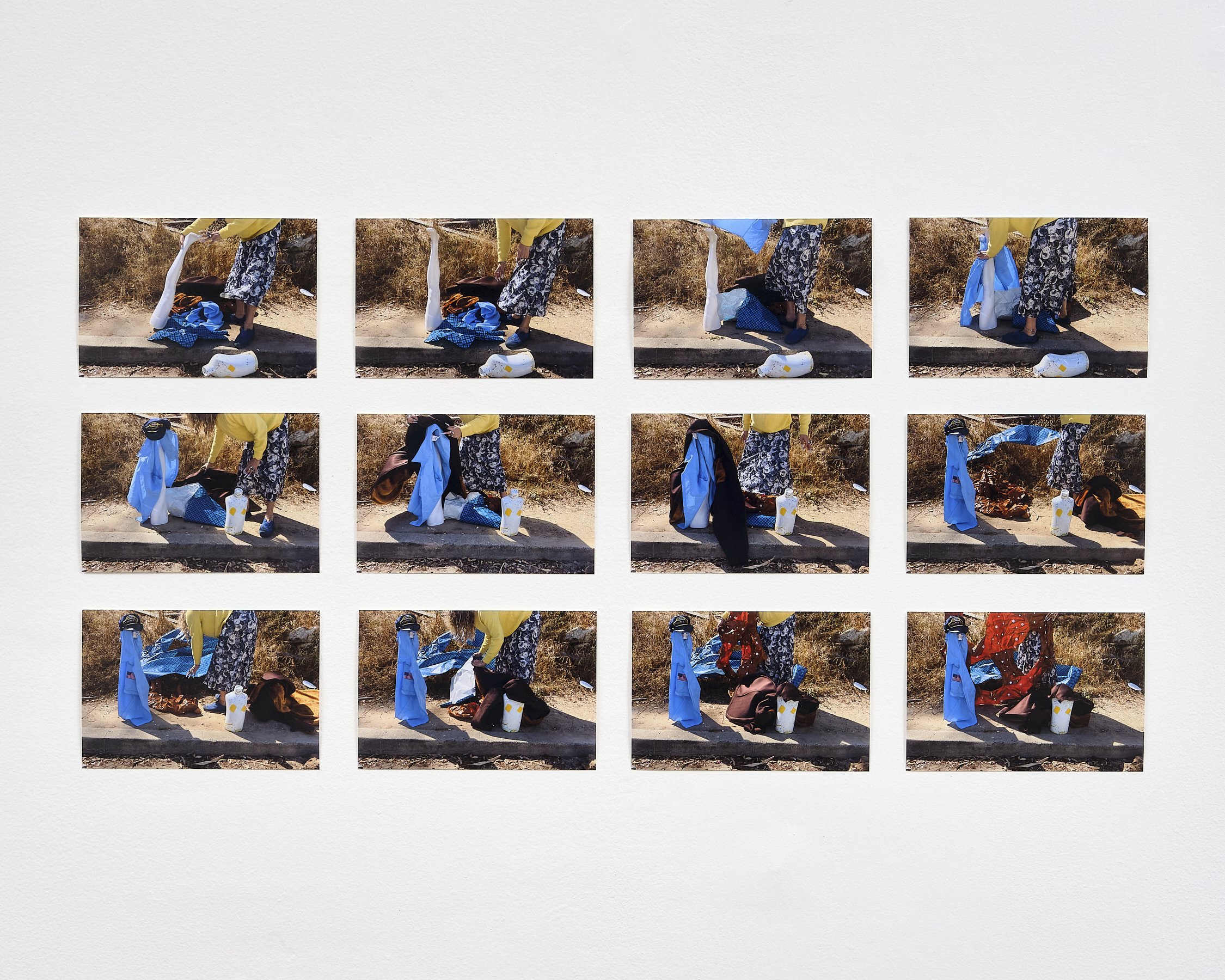 Series of photographs showing a person wearing a yellow top and floral skirt, packing or unpacking items from a blue and white checkered bag on the ground, outdoors with dry grass and a concrete curb.