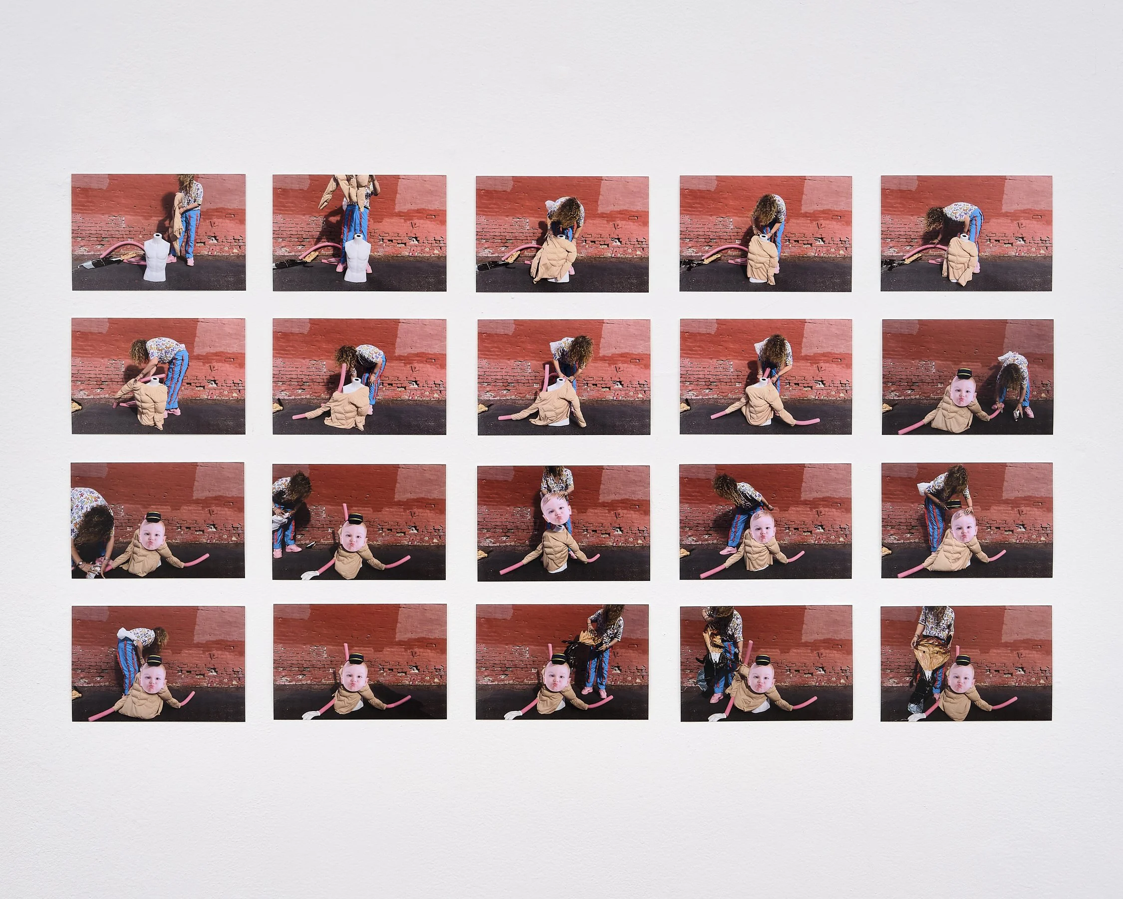 A series of photographs showing a woman and a young child in front of a red brick wall. The woman is dressed in a colorful top and striped pants, and the child is wearing a tan jacket and black hat. They are engaged in playful activities, with the woman bending down and the child sitting or crawling on the ground, with some pink balloons on the ground. The last photo shows the child with a black hat, facing the camera.