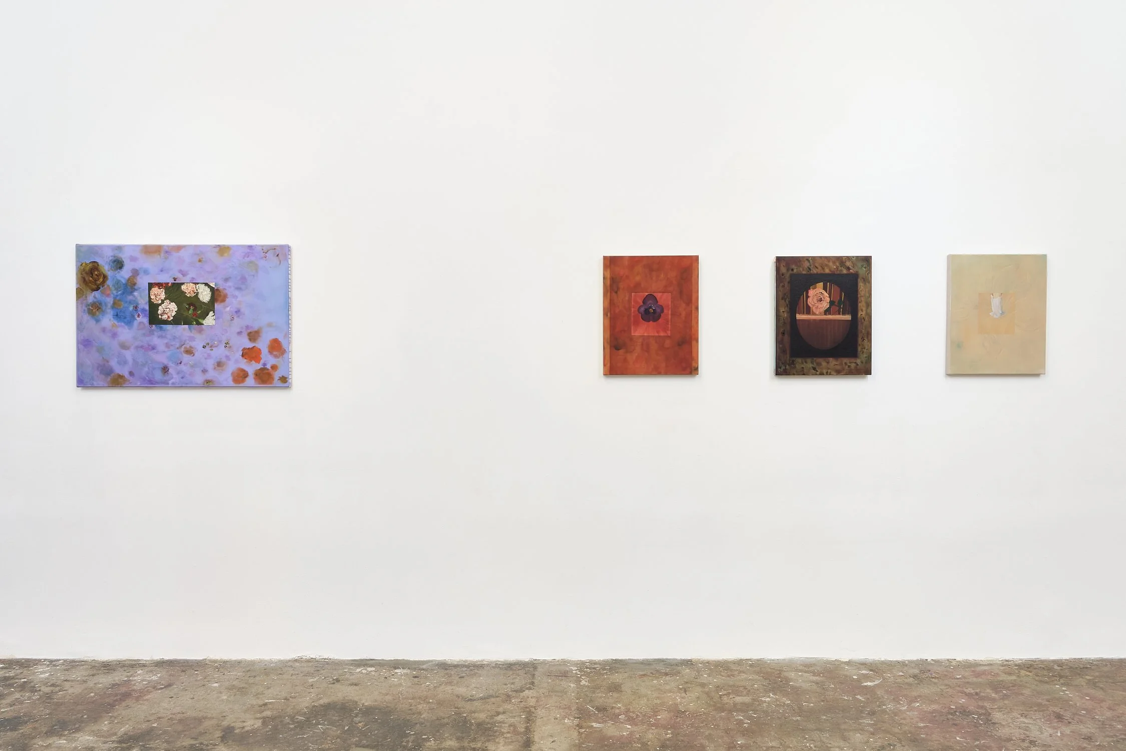 Four abstract paintings displayed on a white gallery wall, with a concrete floor.
