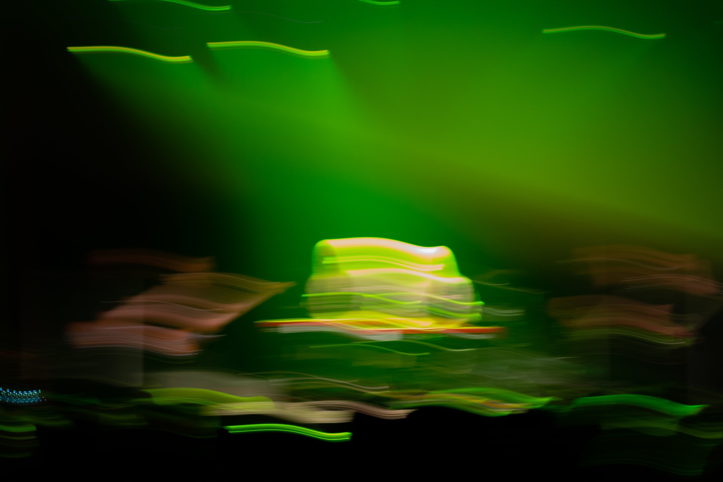 Abstract green and black light streaks and blurred lines.