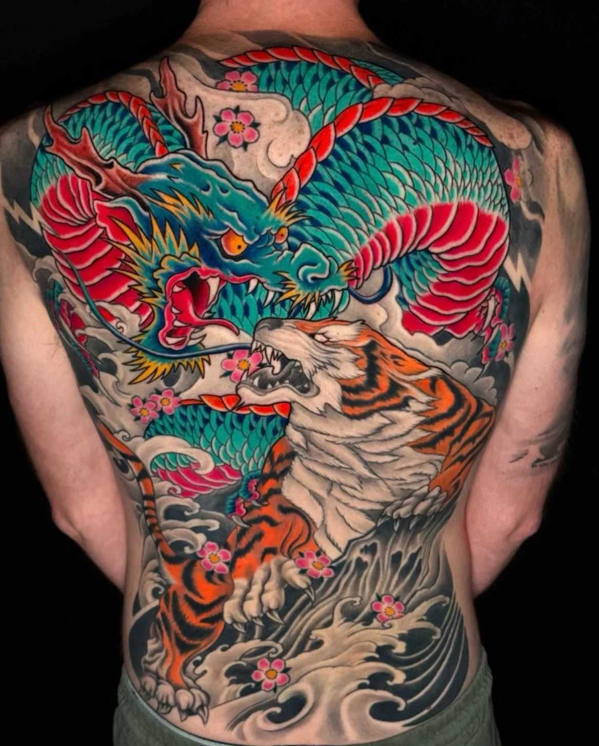Dragon and Tiger 🐉🐅 by @tattsbyethan_ 

#colortattoo #japanesetraditional #backpiece #orientaltattoo #dragontattoo 

Ready to get a back piece ? Book today !