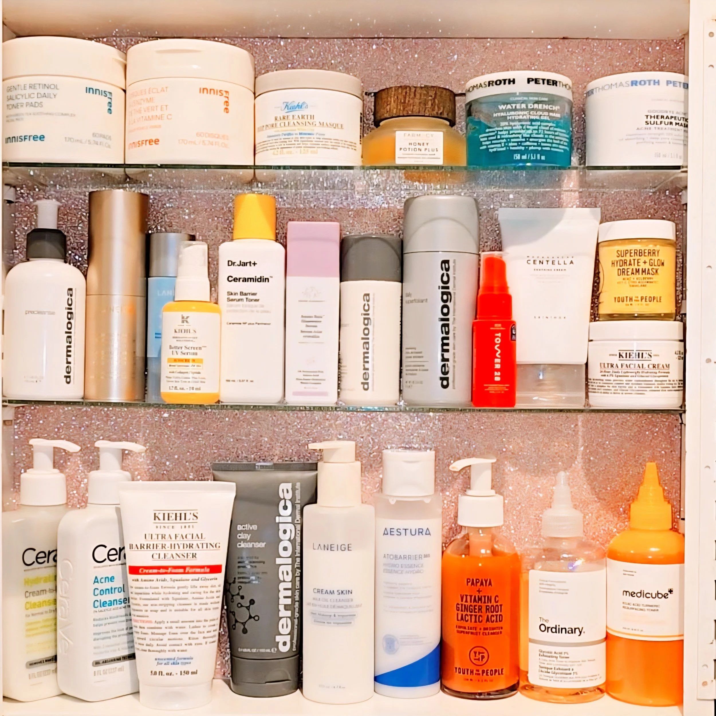 a collection of skincare arranged on shelves 