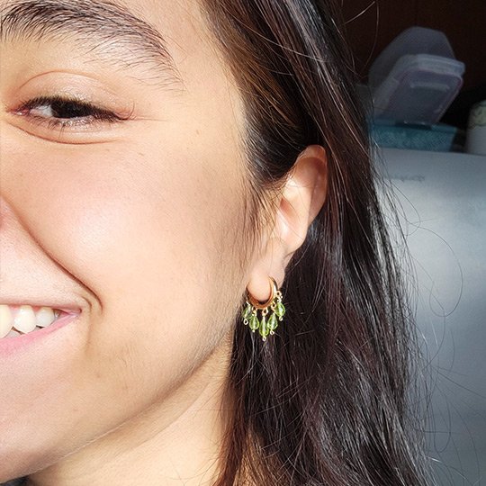 customer wearing peridot earrings