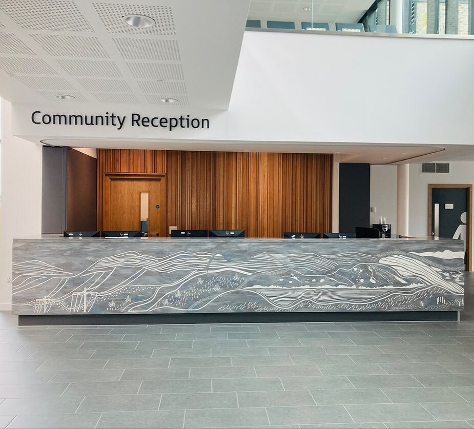 Clydebank Health Centre &bull;A tactile, linear artwork inspired by the Kilpatrick Hills giving a focal point to the entrance of the building. The design was engraved into the Corian reception desk and then infilled with white resin.