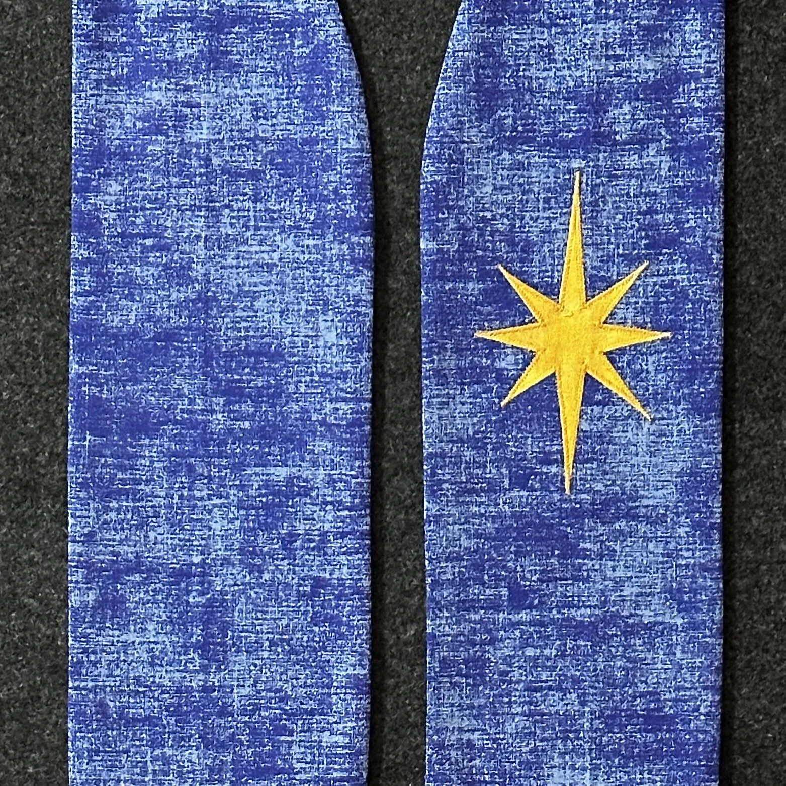 Detail of a blue Advent stole with a gold appliquéd star of Bethlehem on the chest by Carrot Top Studio.