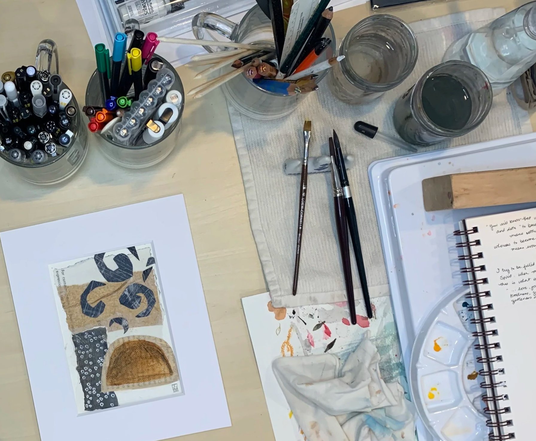 Art supplies, paint brushes, markers, collage materials, sketch book are shown. Creating art is a process for most artists including Jenny Gallo of Carrot Top Studio.