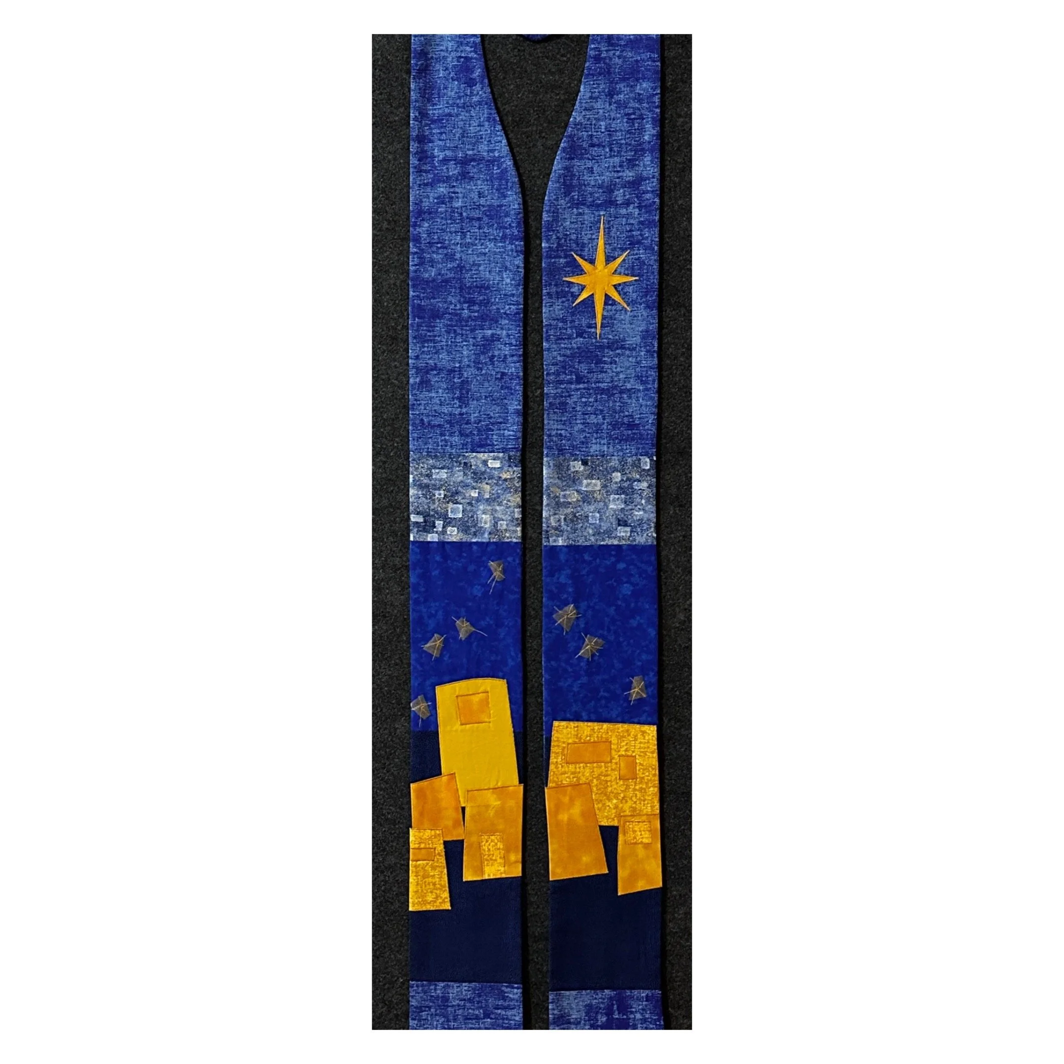 A blue Advent stole with a little town of Bethlehem border and a starry sky for clergy by Carrot Top Studio.