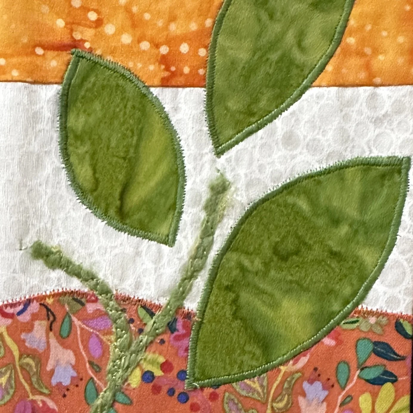 Orange clergy stole with white border, whimsical plant accents, and appliquéd leaves—symbolizing growth, healing, and God’s renewing peace. Carrot Top Studio stole store.
