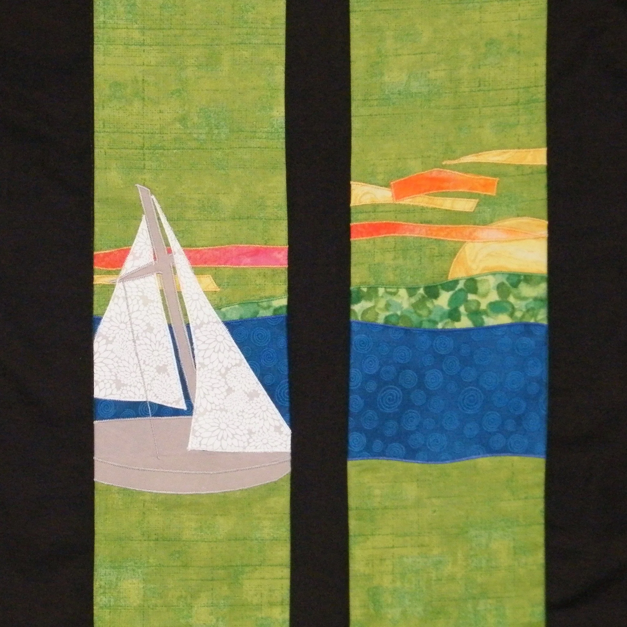 Detail of a green stole with water, land, sunrise, and a sailboat by Carrot Top Studio.