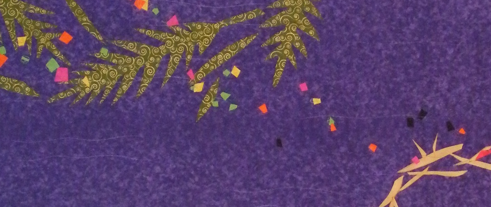 Palm fronds, confetti and a crown of thorns adorn the fabric banner created by Carrot Top Studio for Holy Week during the season of Lent.