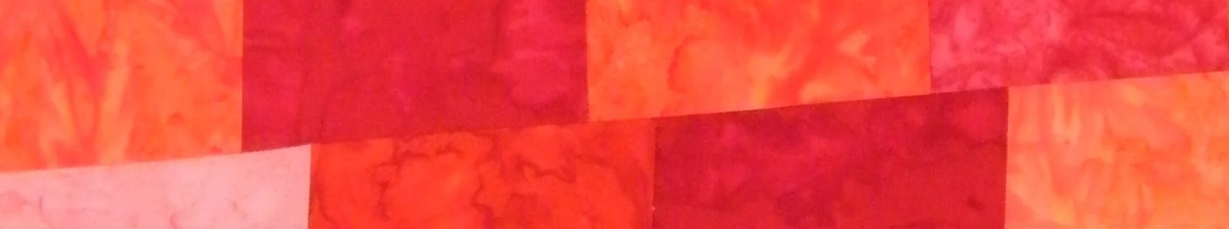 A detail of a pieced red stole for Pentecost and/or ordination to symbolize the Holy Spirit by Carrot Top Studio.