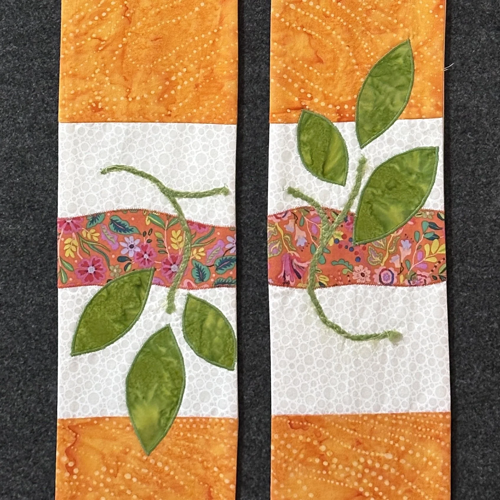 Orange clergy stole with white border, whimsical plant accents, and appliquéd leaves—symbolizing growth, healing, and God’s renewing peace. Carrot Top Studio stole shop.