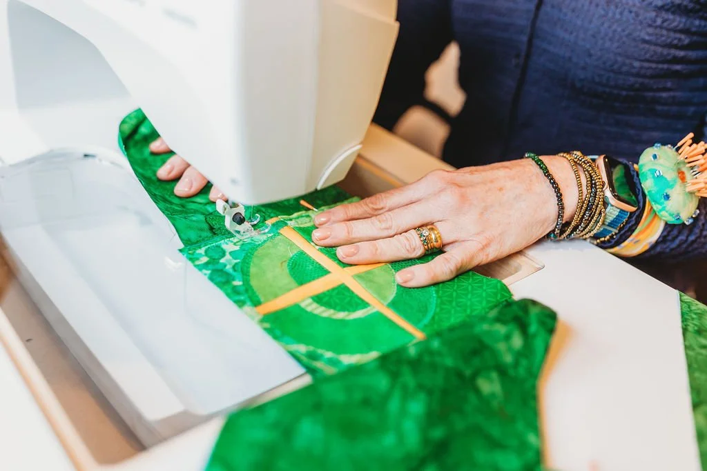 Jenny stitching cross detail on green clergy stole