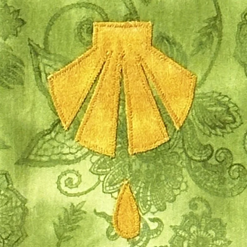A detail of the green ordinary time stole with symbols of the sacraments by Carrot Top Studio.