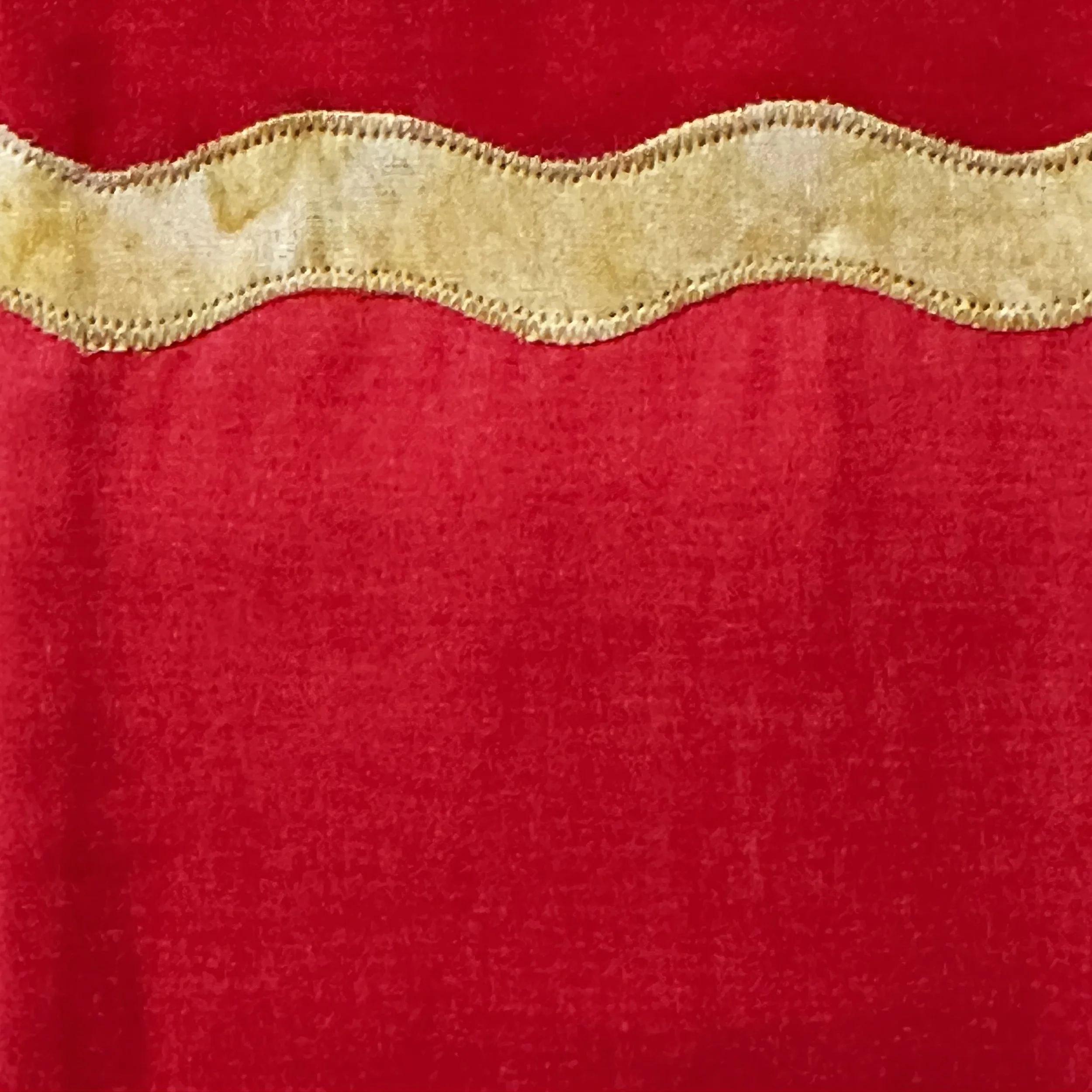 Detail of a red Carrot Top Studio stole with gold accents.