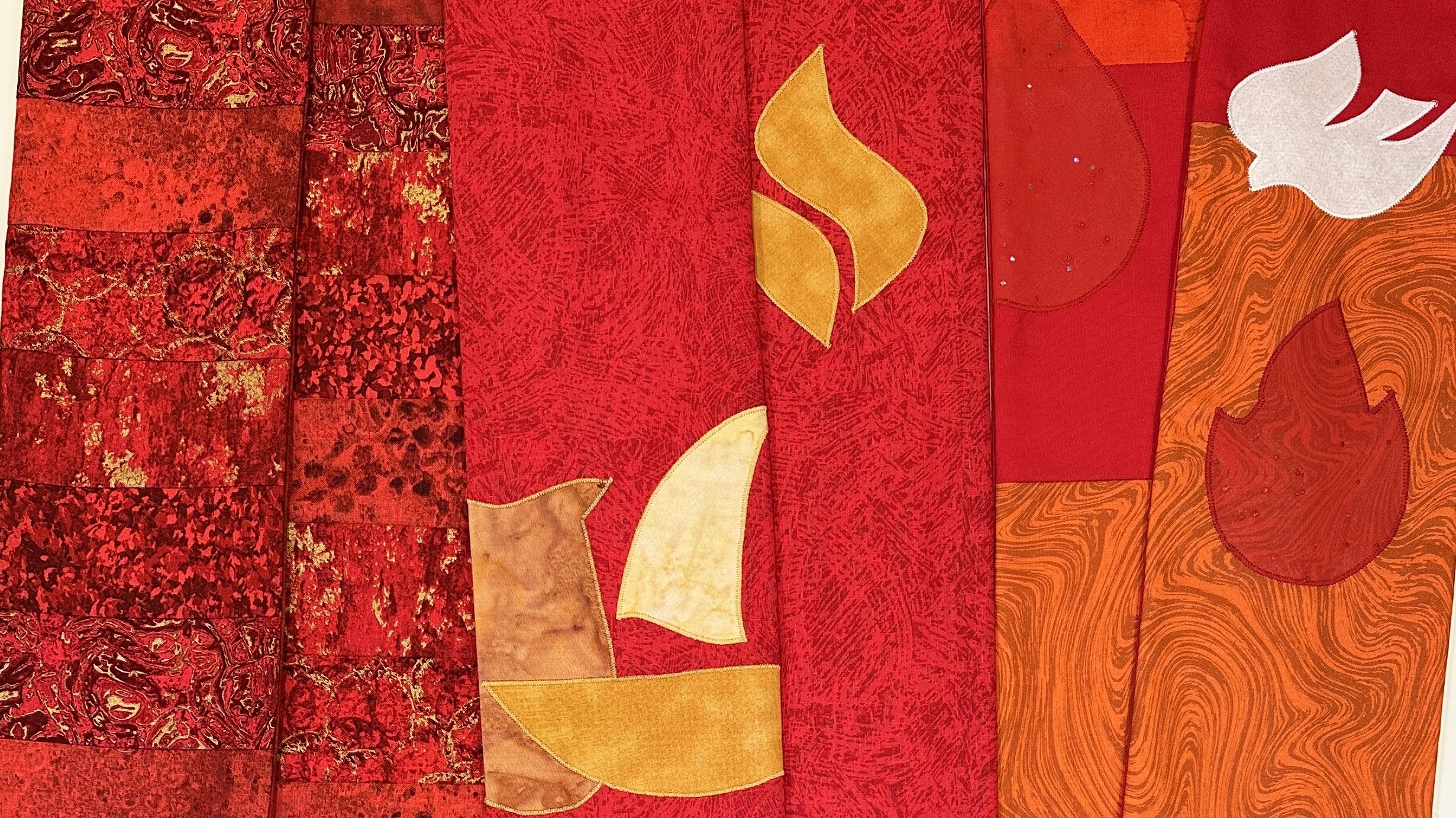 Carrot Top Studio creates story rich liturgical stoles for the church year. This image shows details of red steels for ordination and Pentecost.