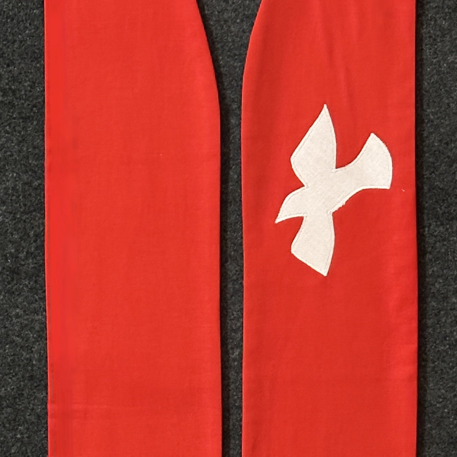 Detail of a red stole with white dove for ordination and Pentecost by Carrot Top Studio.