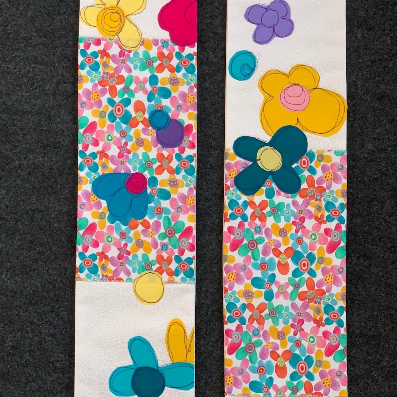 Detail of a white Easter stole with bright colored flowers for clergy, pastors and worship leaders.