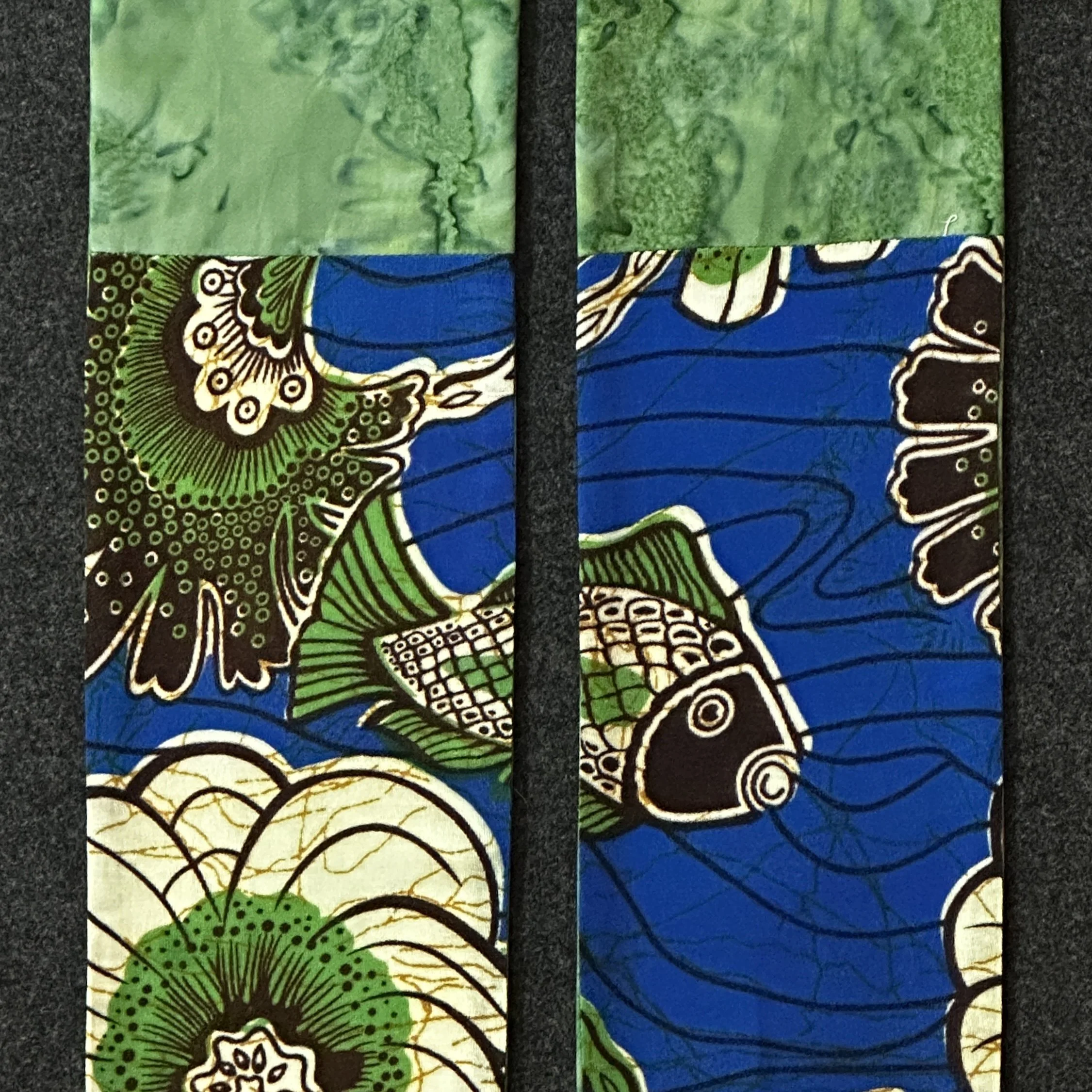 A detail of a green Ordinary Time stole featuring batik fabric that is in the Carrot Top Studio stole store.