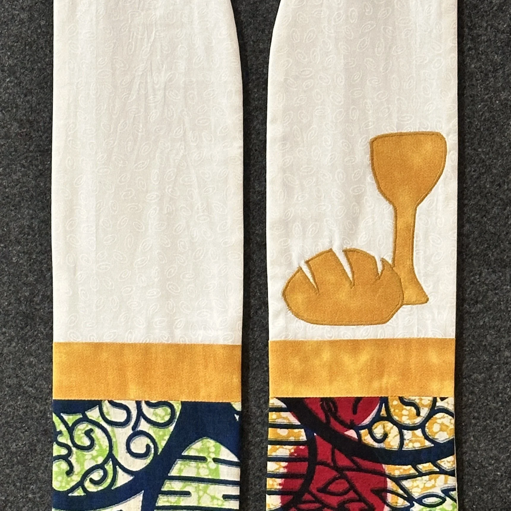 Detail of the table of abundance Communion clergy stole with afrocentric fabric created by Carrot Top Studio.