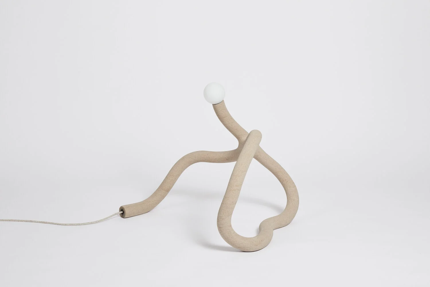 Hot Wire Extensions' Native Light 2. A floor light with natural textile cable and a raw, sealed finish